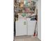 Efficient laundry room features a washer, dryer, storage shelves, and cleaning supplies for convenience at 8213 Claire Ann Dr # 108, Orlando, FL 32825