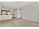 Open living area with carpet flooring adjoining to the kitchen with ample open space at 8213 Claire Ann Dr # 108, Orlando, FL 32825
