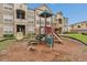 Community playground with colorful play structure, slides, climbing features, and safety surfacing at 8213 Claire Ann Dr # 108, Orlando, FL 32825