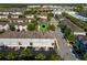 Aerial view of a townhouse with a green location pin surrounded by trees and other townhouses at 861 Taramundi Dr, Oviedo, FL 32765