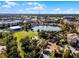 Picturesque aerial view featuring a tranquil lake with a fountain, a gazebo and surrounding lush landscapes and sidewalks at 861 Taramundi Dr, Oviedo, FL 32765