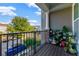 Cozy balcony filled with potted plants that looks out to a neighborhood street lined with trees at 861 Taramundi Dr, Oviedo, FL 32765