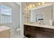 Updated half bathroom with double sink vanity and window at 861 Taramundi Dr, Oviedo, FL 32765