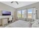 Bright carpeted bedroom with desk and large windows at 861 Taramundi Dr, Oviedo, FL 32765