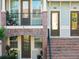 Close-up of brick stairs leading to townhome entrances, each with a small balcony and potted plants at 861 Taramundi Dr, Oviedo, FL 32765