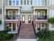 Charming entrance with brick stairs leading to front doors, adorned with wreaths and small balconies with seating at 861 Taramundi Dr, Oviedo, FL 32765