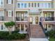 Welcoming townhome exterior with a brick facade, covered balconies, and attractive landscaping at 861 Taramundi Dr, Oviedo, FL 32765