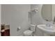 Clean half bathroom features a pedestal sink, toilet, decorative shelf, and tile flooring at 861 Taramundi Dr, Oviedo, FL 32765