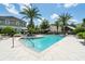 Inviting community pool with palm trees, lounge chairs and covered gazebo with a beautiful serene seating area at 861 Taramundi Dr, Oviedo, FL 32765