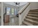 Bright interior view showing the staircase, with views of the living room and outdoor patio area at 861 Taramundi Dr, Oviedo, FL 32765