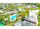 Aerial view of neighborhood community pool, tennis court, lake and bridge at 9126 Shadowbrook Trl, Orlando, FL 32825