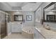 Well-lit primary bathroom with a soaking tub, frameless shower, and dual sink vanity at 9126 Shadowbrook Trl, Orlando, FL 32825