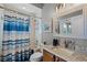 Bright bathroom features a tub and shower combination with a granite countertop vanity at 9126 Shadowbrook Trl, Orlando, FL 32825
