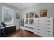 Well-lit bedroom with hardwood floors, white shelving, a desk, and a large window at 9126 Shadowbrook Trl, Orlando, FL 32825