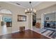 Dining room featuring hardwood floors, an elegant chandelier, and easy access to the kitchen and office at 9126 Shadowbrook Trl, Orlando, FL 32825