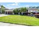 Charming single-story home with a three-car garage, lush landscaping, and a well-manicured lawn at 9126 Shadowbrook Trl, Orlando, FL 32825