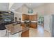 Open concept kitchen features granite countertops, stainless appliances, and easy access to the living area at 9126 Shadowbrook Trl, Orlando, FL 32825