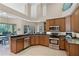 The kitchen features wood cabinetry, stainless steel appliances, granite counters and a breakfast bar at 9126 Shadowbrook Trl, Orlando, FL 32825