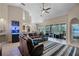 Spacious living area featuring tile flooring, modern furniture, and sliding glass doors to the lanai at 9126 Shadowbrook Trl, Orlando, FL 32825