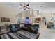 Open-concept living room with vaulted ceilings, tile floors, and comfortable leather seating at 9126 Shadowbrook Trl, Orlando, FL 32825