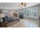 Spacious main bedroom with stylish furniture, ceiling fan, and large windows for natural light at 9126 Shadowbrook Trl, Orlando, FL 32825