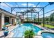 Refreshing screened-in pool with spa, beautiful landscaping, and an outdoor lounge area at 9126 Shadowbrook Trl, Orlando, FL 32825