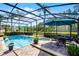 Stunning screened-in pool with spa, outdoor seating, and views of the lush landscaping at 9126 Shadowbrook Trl, Orlando, FL 32825