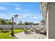 Inviting backyard features a stone patio with lounge furniture, fire pit, string lights, and a well-manicured lawn at 715 Braidwood Ln, Orlando, FL 32803
