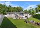 The backyard offers a lovely stone patio with outdoor seating, a barbecue grill, and a charming fire pit area at 715 Braidwood Ln, Orlando, FL 32803