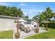 A stone patio with seating, a grill, and potted plants enhance the backyard's appeal for relaxation and entertainment at 715 Braidwood Ln, Orlando, FL 32803