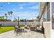 Outdoor patio area with furniture, a fire pit, lawn and white privacy fence at 715 Braidwood Ln, Orlando, FL 32803
