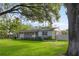 A well-kept single-story home featuring a lush green lawn at 715 Braidwood Ln, Orlando, FL 32803