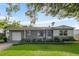 Charming single-story home with well-maintained lawn and landscaping at 715 Braidwood Ln, Orlando, FL 32803