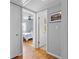 Hallway leading to a bedroom and bathroom with hardwood floors and gray walls at 715 Braidwood Ln, Orlando, FL 32803