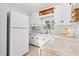Bright kitchen with white cabinetry, stainless sink, and white appliances with wood look flooring at 715 Braidwood Ln, Orlando, FL 32803