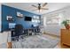 Bright office with dual workstation setup, decor shelves, modern ceiling fan and stylish light fixture at 715 Braidwood Ln, Orlando, FL 32803
