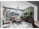 Bright sun room features checkered floors, an entertainment center, and a cozy leather sofa and ottoman at 715 Braidwood Ln, Orlando, FL 32803