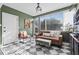 Bright sunroom with checkered floors, comfortable seating, and ample natural light at 715 Braidwood Ln, Orlando, FL 32803
