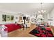 Bright living room, open concept with modern light fixture, hardwood floors, and stylish furnishings at 10452 Log House Rd, Clermont, FL 34711
