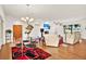 Living room with adjacent dining area, modern decor, hardwood floors and natural light at 10452 Log House Rd, Clermont, FL 34711