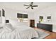 Cozy main bedroom with ceiling fan features a large window and view to the yard at 10452 Log House Rd, Clermont, FL 34711