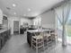 Modern kitchen featuring gray cabinets, an island with seating, and stainless steel appliances at 1225 Greenley Ave, Groveland, FL 34736