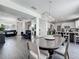 Open concept living area with modern furnishings and decor flowing into the dining and kitchen area at 1225 Greenley Ave, Groveland, FL 34736