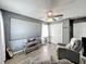 Comfortable living area with neutral decor, a ceiling fan, and a large projection screen at 1225 Greenley Ave, Groveland, FL 34736