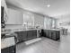 Modern kitchen featuring white cabinets, granite countertops, and stainless steel appliances at 1225 Greenley Ave, Groveland, FL 34736