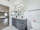 Well-lit bathroom featuring dual sinks with modern lighting and vanity at 1225 Greenley Ave, Groveland, FL 34736