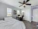 Comfortable bedroom with natural light, ceiling fan, and closet for easy storage at 1225 Greenley Ave, Groveland, FL 34736