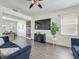 Comfortable living area with hardwood floors, modern furniture, and a view of the dining room at 1225 Greenley Ave, Groveland, FL 34736