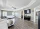 Spacious main bedroom featuring tray ceilings, wood-look floors, and natural lighting at 1225 Greenley Ave, Groveland, FL 34736