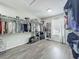Spacious walk-in closet featuring wood-look floors, custom shelving, and hanging rods for optimal storage and organization at 1225 Greenley Ave, Groveland, FL 34736